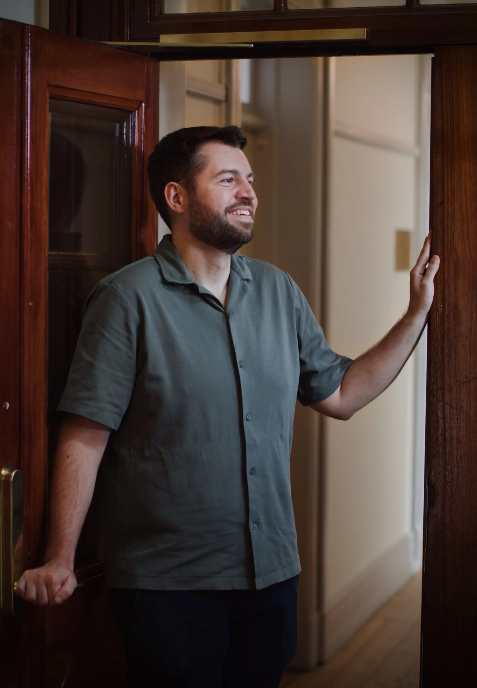 Martin leaning in the office doorway